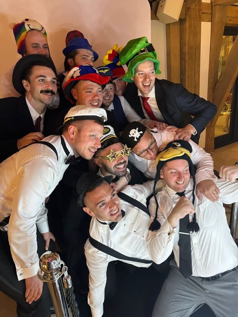 Wedding guests with photo booth props at The Old Kent Barn