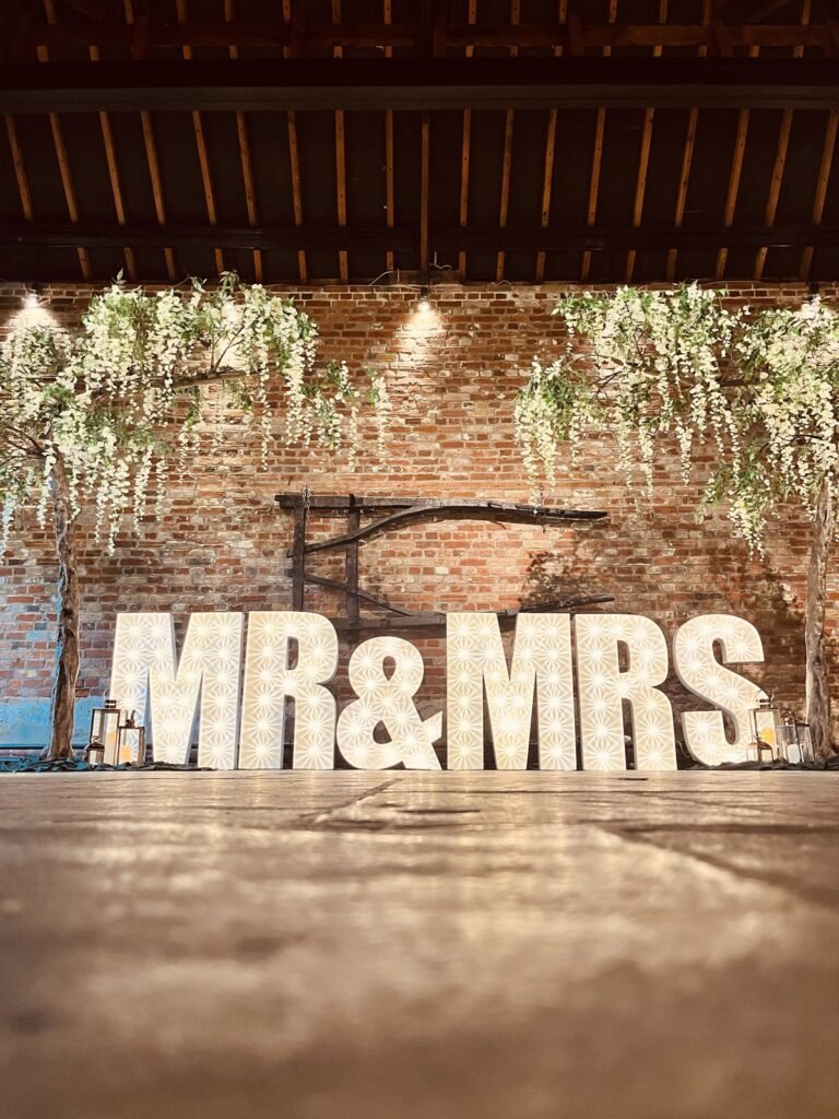 MR & MRS illuminated letters on the dance floor at Cooling Castle Barn